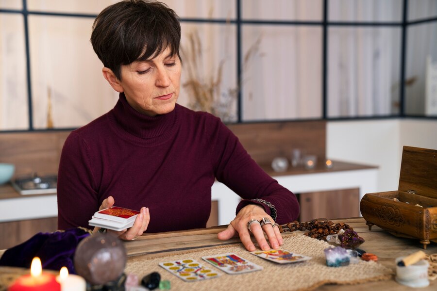 medium-shot-senior-woman-reading-tarot_23-2150298303